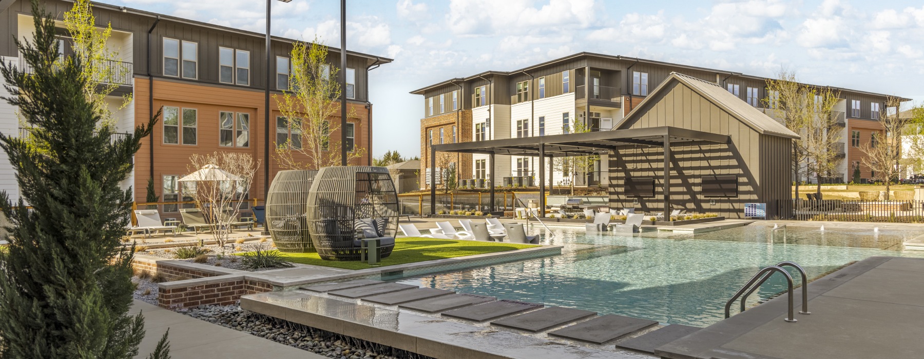 a pool in a courtyard with buildings in the background