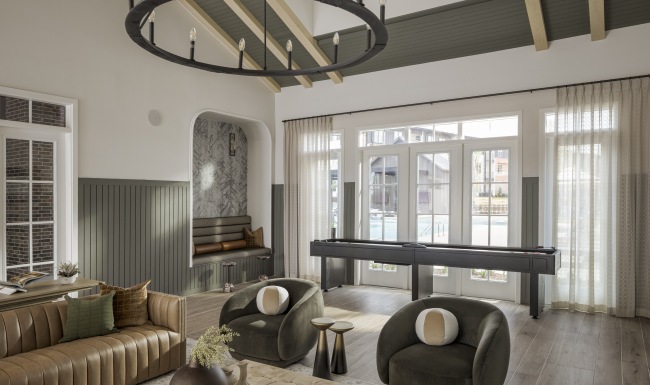 a lobby with a large glass door and sitting areas